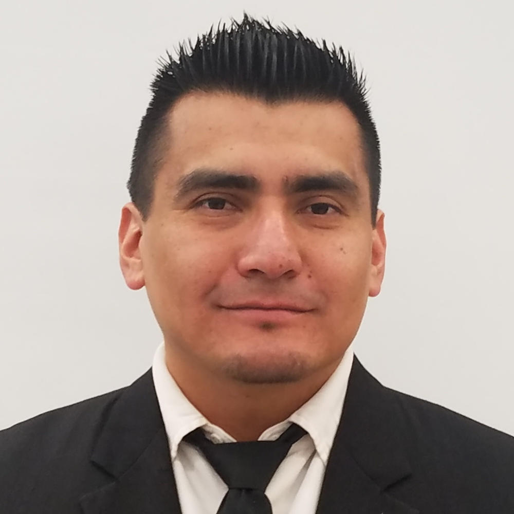 Edgar Salinas, a man with gelled black hair in a suit